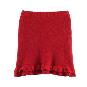 Detail view of red knitted mini skirt featuring tiered ruffle hem and ribbed high waist