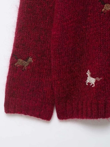 Close-up of dark red mohair knit cardigan featuring exquisite horse bead embroidery details