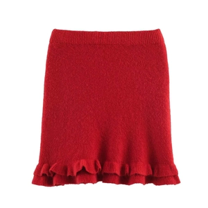 Detail of red knit skirt with ribbed waist and double-layered ruffle hem design