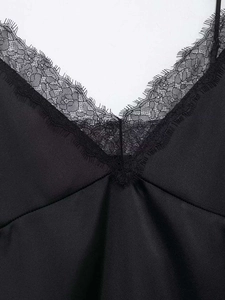 Detail showing the exquisite black eyelash lace trim on a satin V-neck camisole top