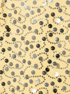 Close-up of yellow fabric with intricate silver sequins and decorative wave patterns