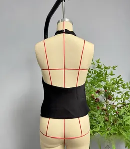 Detailed back view of a black satin halter top with open back on a mannequin