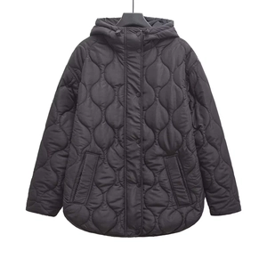 Detailed close-up of a black hooded quilted jacket with unique wavy stitching and snap buttons
