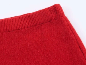 Detailed close-up of red knit set featuring elastic ribbed waistband and soft fuzzy texture