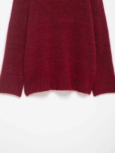 Detailed macro view of the wine red mohair knit cardigan hem and soft ribbed sleeve cuff