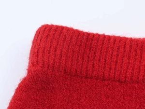 Detailed close-up of soft red mohair knit fabric with ribbed collar and plush texture