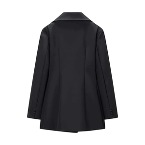 Detail view of the tailored back design and sleeve buttons of this black blazer dress