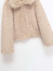Close-up of the soft faux fur texture and elegant oversized lapel on a beige winter coat