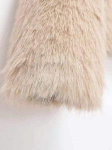 Close-up of soft beige faux fur texture showing premium fluffy plush material detail