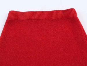 Detail of red knit fabric featuring ribbed elastic waistband and soft brushed texture