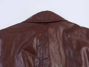 Close-up of the vintage dark brown faux leather jacket collar and back stitching texture