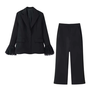 Women's black two-piece suit featuring tailored blazer with fringe feather sleeves and trousers