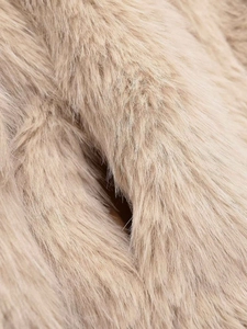 Detailed macro view of soft apricot faux fur texture for winter cropped jacket