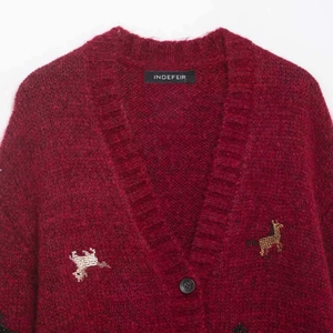 Wine red mohair knit cardigan with V-neck and sequined reindeer pattern in a close-up