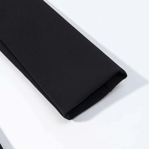 Close-up of black blazer dress sleeve cuffs showing fine woven fabric texture