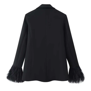 Back view of a black blazer featuring stylish faux feather fringe cuffs on the sleeves