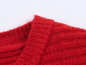 Detail of red mohair knit top showing soft textured fabric and ribbed neckline