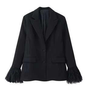 Detail of black blazer featuring luxurious feather trim cuffs and classic notch lapels