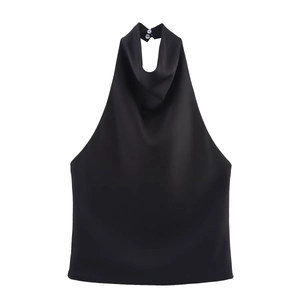 Detail of black satin halter top featuring a deep V-neck and button closure on back