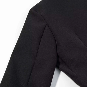 Detail of premium stitching on shoulder seam of black double-breasted blazer dress