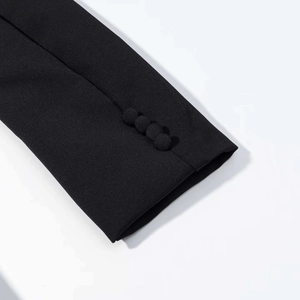 Detail of black blazer sleeve with four fabric-covered buttons on high-quality woven fabric