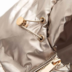 Detail of metallic champagne cotton coat featuring drawstring toggle and zip closure