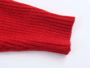 Macro shot of red ribbed knit sleeve cuff showing soft mohair wool blend texture