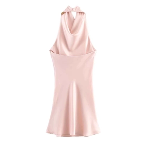 Detail of pink satin sleeveless dress featuring an elegant draped cowl back design