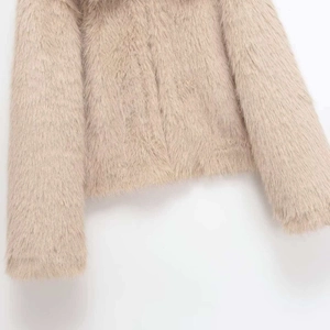 Elegant beige faux fur short jacket with fluffy texture and clean cut on white background