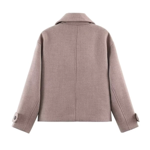 Detail view of the back of a vintage cropped wool jacket with adjustable sleeve straps