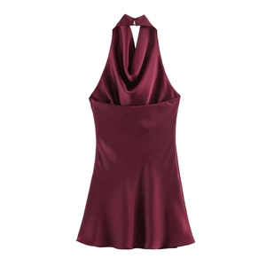 Detail view of burgundy satin dress showing the elegant halter neck and draped neckline