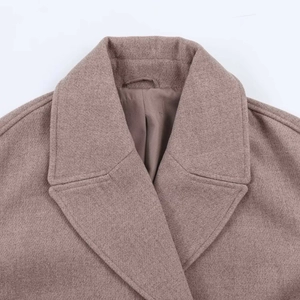 Macro detail of classic peak lapel and premium textured wool fabric on brown coat