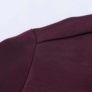 Detailed close-up showing the refined fabric texture and stitching of the purple shirt shoulder