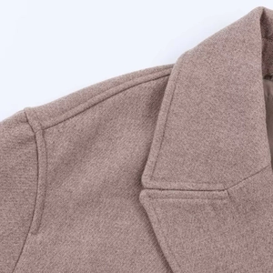Close-up of taupe wool blend jacket featuring notched lapels and precise stitching detail