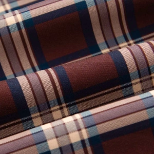 Macro shot of retro plaid bomber jacket fabric showing twill weave and color texture