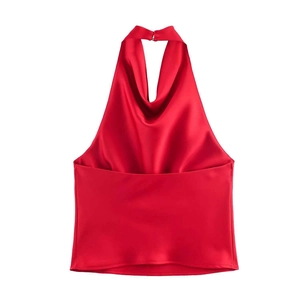 Detail of red satin halter top featuring silky texture and elegant draped neckline fold