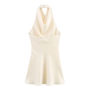 Detail of cowl neck and satin fabric texture on white backless halter mini dress