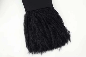 Close-up of black suit sleeve featuring premium faux fur trim and textured fabric details