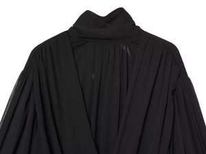 Detail of elegant black pleated fabric with sheer texture and stylish high-neck design