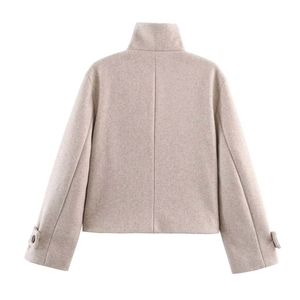 Rear view of a cropped wool jacket in oatmeal with a stand collar and cuff strap details