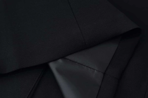Detailed close-up showing smooth black fabric lining and premium stitching of the suit