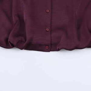 Detail of a vintage purple loose shirt showing silk texture and matching resin buttons