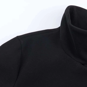 Detailed close-up showing the stand collar and stitching of the black short wool jacket