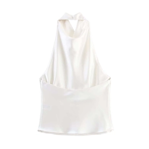 Detail of white halter neck silk top featuring smooth satin texture and elegant backless cut