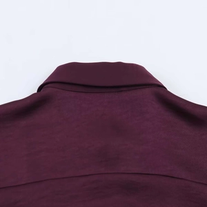 Detail of vintage purple loose shirt showing neckline and smooth silk-like fabric texture
