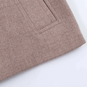 Macro detail of twill weave fabric and seamless pocket stitching on a wool jacket