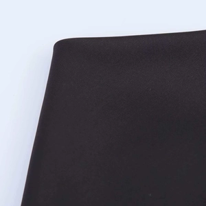 Close-up of premium black fabric texture with high-density synthetic fiber weaving