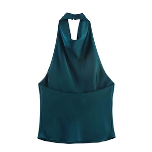 Close-up of the elegant dark green satin fabric texture and pleated halter neckline detail