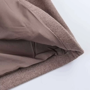 Detailed macro view of brown wool jacket lining with high-quality seam construction
