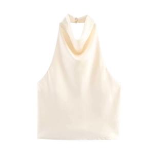 Detail of elegant cream satin halter top featuring a draped cowl neck and button closure